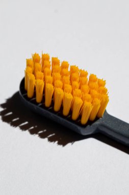 New orange toothbrush close-up. Macro.