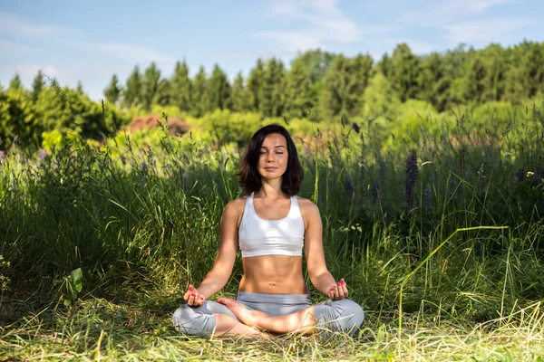 Young woman doing yoga outdoor