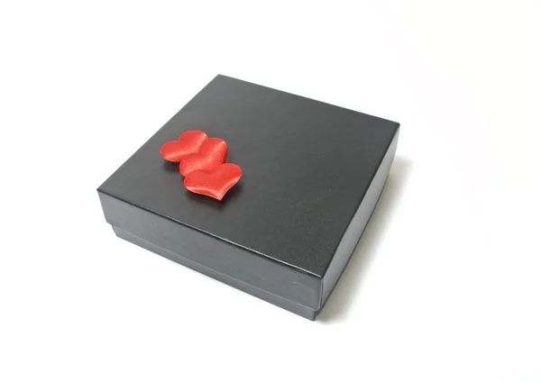 Black box and three red heards — Stock Photo, Image