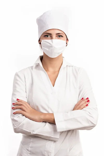 Young doctor standing with arms folded over white — Stock Photo, Image