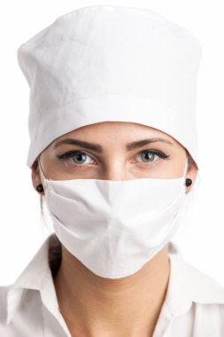 maske ve bir şapka giyen genç kadın doktor closeup