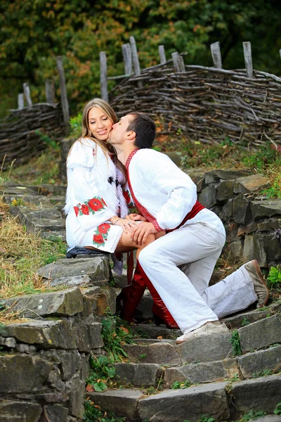 Young romantic couple in Ukrainian style clothes outdoors — Stock Photo, Image