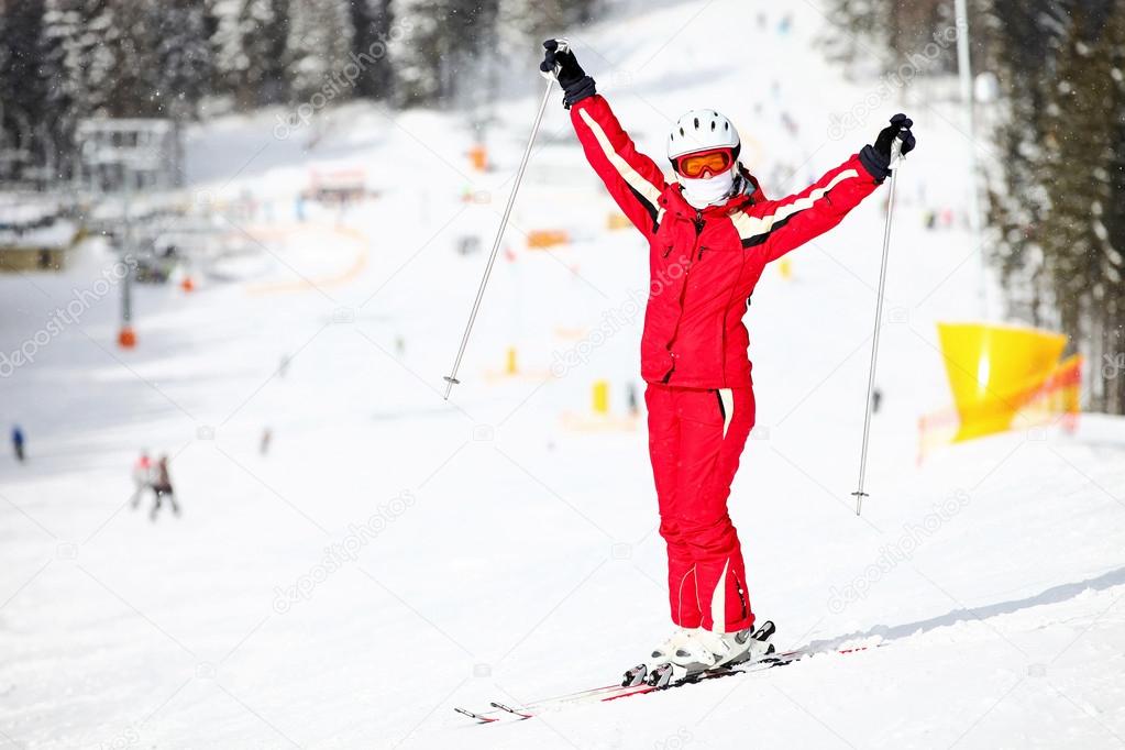 Portrait of happy female skier on mountain slope