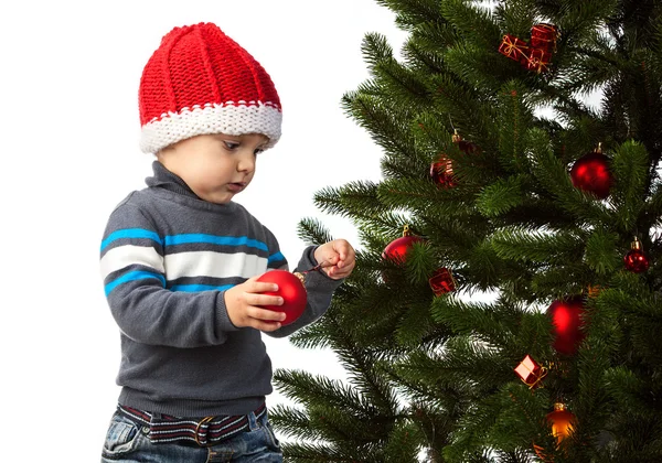 Cute little boy decorating Christmas tree — Stock Photo, Image