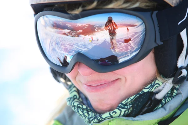 Closeup portrait of a female skier standing on a skiing slope — Stock Photo, Image