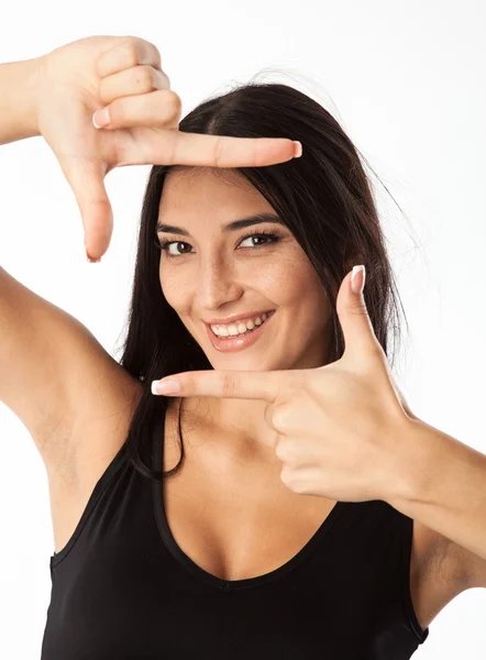 Retrato de una joven hermosa mujer haciendo marco con sus manos sobre blanco — Foto de Stock