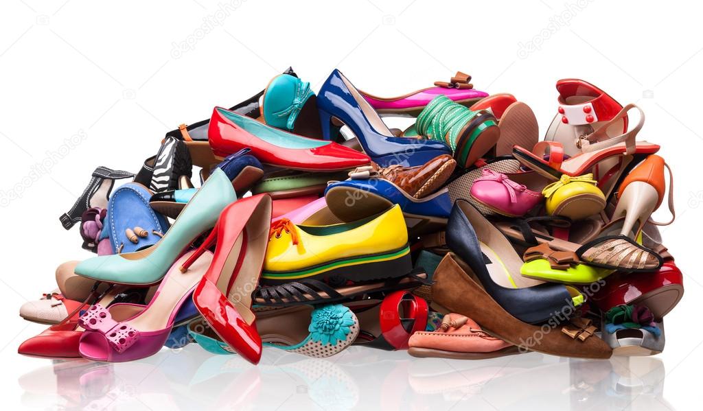 Pile of various female shoes over white