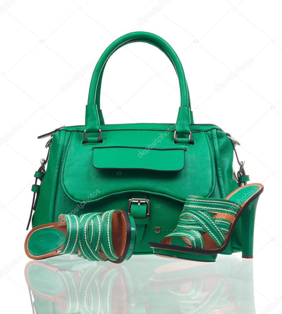 Green summer shoes and handbag over white