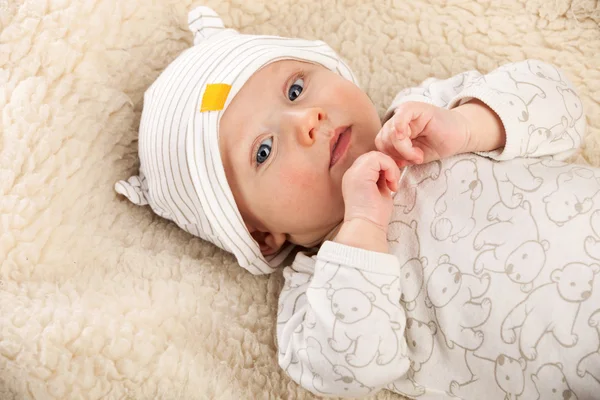 Closeup portrait of baby boyis a sheep-blanket — Stock Photo, Image