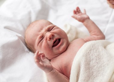 Closeup of newborn baby crying clipart
