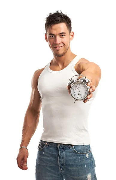 Cropped view of a muscular young man holding clock. It is time for workout concept. — Stock Photo, Image