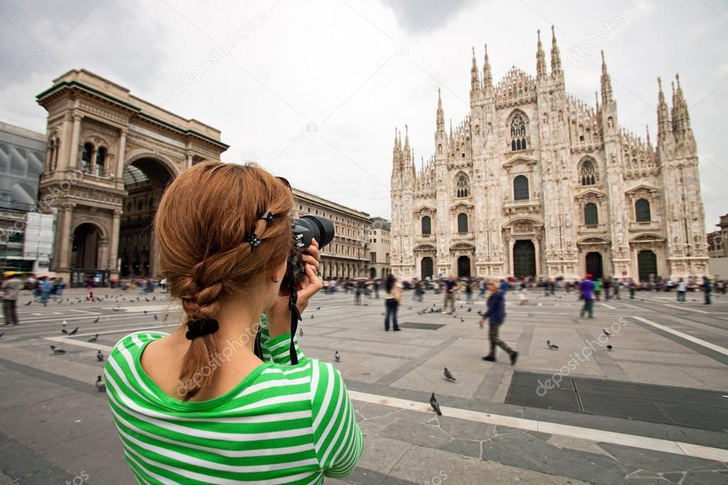 Woman taking picture of Duomo di Milano, Italy