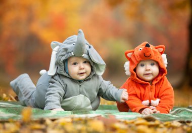 Two baby boys dressed in animal costumes