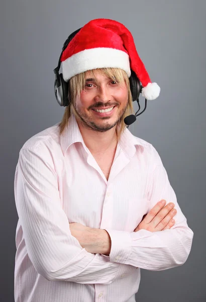 Caucasian man wearing headset with christmas hat — Stock Photo, Image