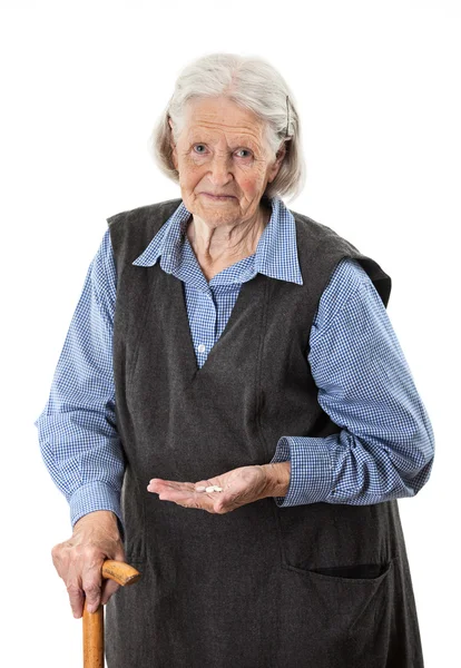 Mujer mayor sosteniendo medicamentos sobre blanco — Foto de Stock
