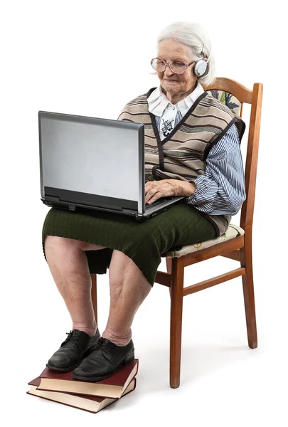 Senior woman using laptop computer ower white — Stock Photo, Image