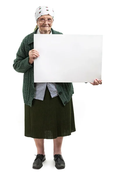 Smiling elderly lady holding blank sheet in hands — Stock Photo, Image