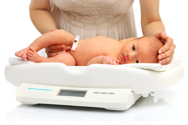 Mother and her newborn baby on a weight scale — Stock Photo, Image