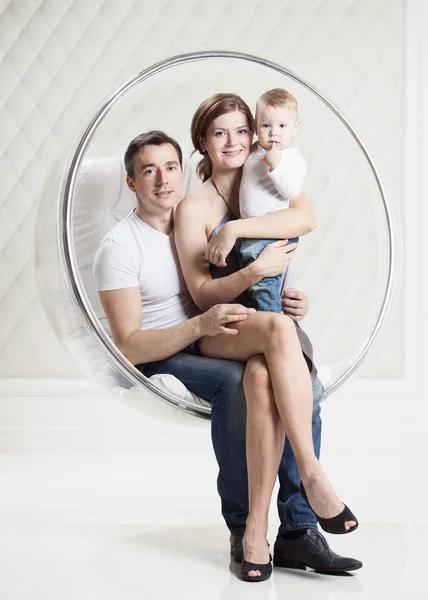 Family with baby boy on swinging hanging chair — Stock Photo, Image