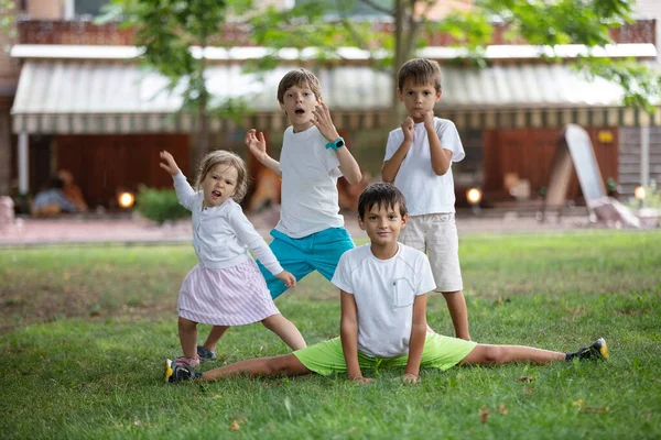 Three Young Boys Toddler Girl Making Funny Faces Outdoors Friends — Foto de Stock