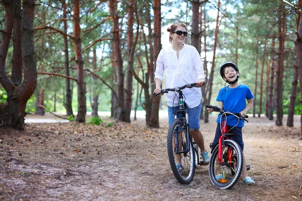 Cheerful Mother Son Riding Bicycle Forest — Stockfoto