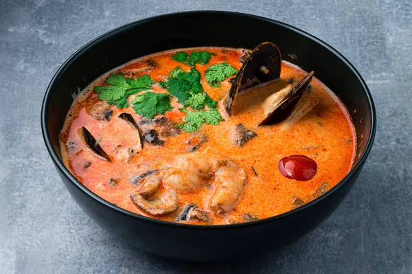 classic tom yam with mussels, Traditional spicy Thai soup Tom Yum with shrimp and seafood, classic dish of cuisine of Thailand