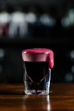 Shot of a cocktail with froth, alcoholic cocktail shot with burgundy foam clipart