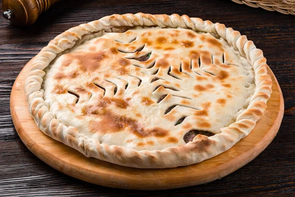 classic Ossetian pie with filling, homemade dietary ossetian pie with cabbage and brisket. National pastries Ossetian pies with different fillings