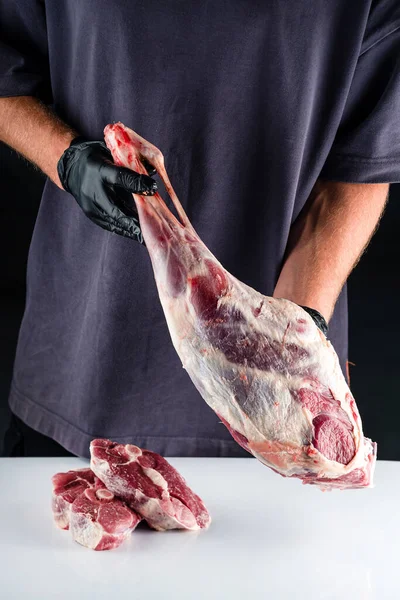 生羊腿在厨师手里 男屠夫手里拿着生肉羊腿肉 古代饮食 有机食品 — 图库照片