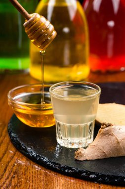 Bal ve zencefil karışımı bardakta. Zencefil köklü antiviral alkol tentürü, bağışıklık sisteminin güçlendirilmesi