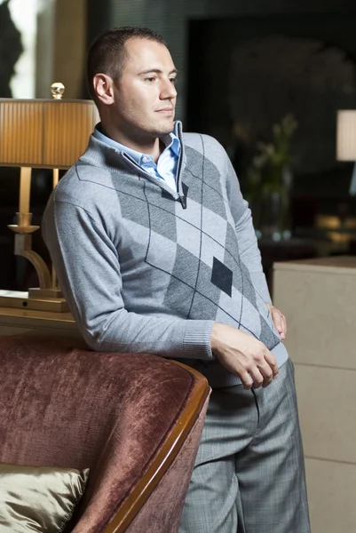 Good looking yang man posing in hotel lobby — Stock Photo, Image