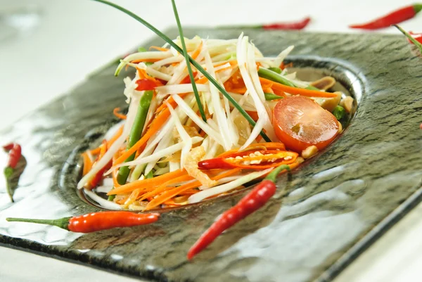 Plate of Thai salad arranged with red chilly peppers