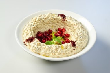 Oriental Arabic food hummus with pomegranate seeds clipart