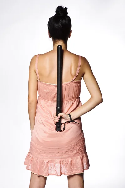 Studio portrait of yang and beautiful brunette woman holding police stick — Stock Photo, Image