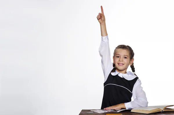 Estúdio retrato de adorável menina da escola pequena levantar a mão — Fotografia de Stock