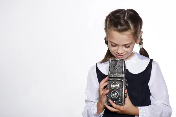 Studio portrait of adorable small school girl with vintage camera — Stock Photo, Image