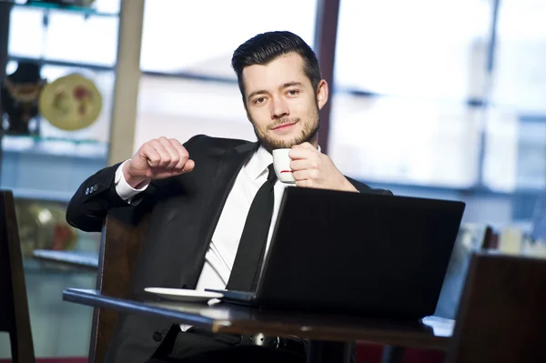 Portrait of yang confident businessman in interior — Stock Photo, Image