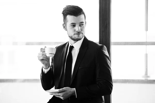 Portrait of yang confident businessman in interior — Stock Photo, Image