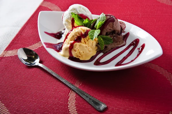 Many-colored scoops of exclusive ice cream on narrow plate — Stock Photo, Image