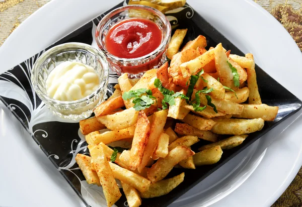 Plate of French fries with white and red sauces — Stock Photo, Image