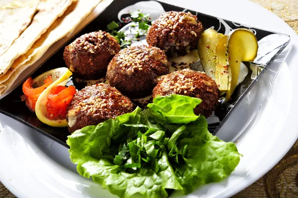 Tasty felafels meal with greens and pickles — Stock Photo, Image