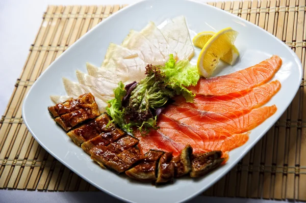 Plate of sliced red and white salmon — Stock Photo, Image