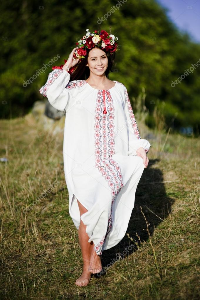 Outdoor portrait of yang and beautiful Slav woman dressed traditional way