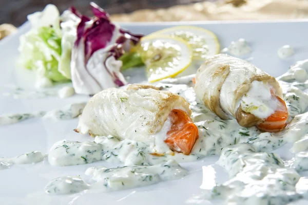 Plate of flatfish roll staffed with red salmon — Stock Photo, Image