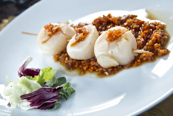 Plate of scallop in red sauce — Stock Photo, Image