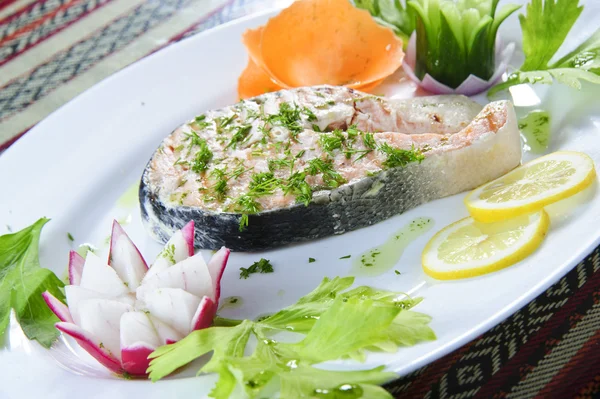 Plate of baked red salmon steak topped with dil — Stock Photo, Image
