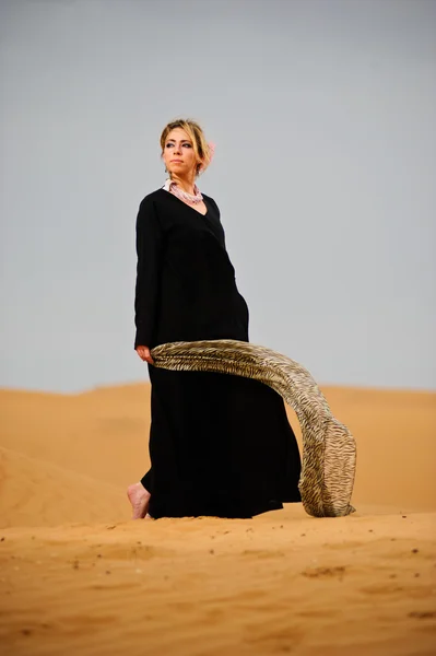 Portrait of arabic way dressed woman in yellow desert — Stock Photo, Image