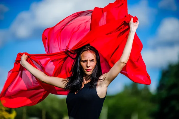 Picture of sexy yang dark haired women with red fabric — Stock Photo, Image