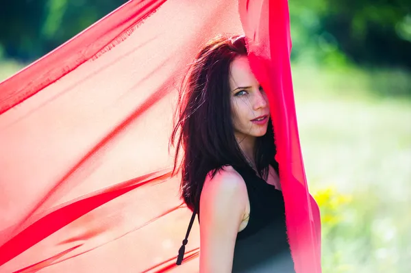 Picture of sexy yang dark haired women with red fabric — Stock Photo, Image