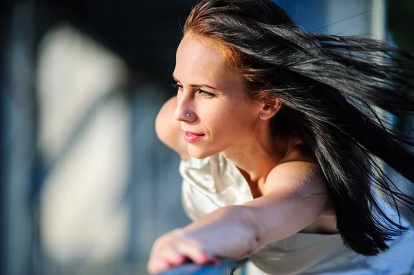 Portrait of beautiful yang brunette in silver dress — Stock Photo, Image